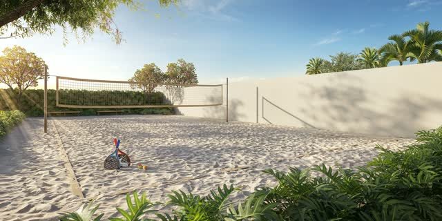 Quadra de areia com rede e muro branco, cercada por vegetação